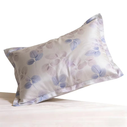 Soft silk pillowcase with a subtle purple and gray leaf pattern on a white background.
